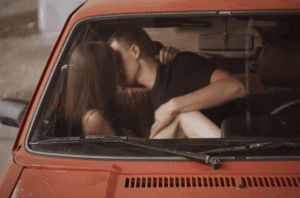 Man and Woman Kissing in a Car